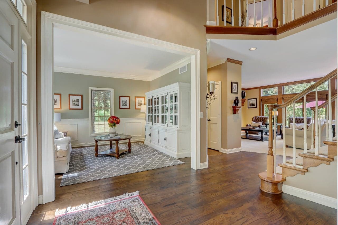 Bright, professionally presented home interior with hardwood floors and a staircase